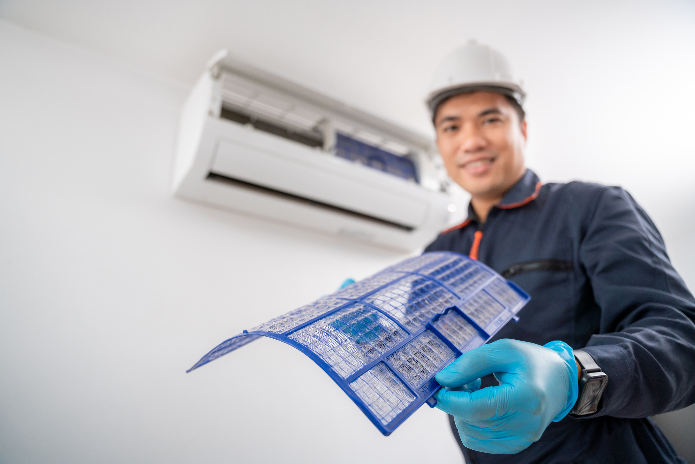 Air conditioner technician removes the air conditioner filter an